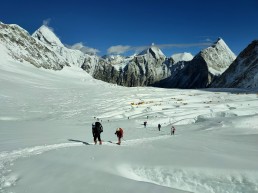Porters and climbers are walking on the glacier on the way to Everest summit